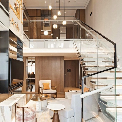Interior staircase glass railing system for loft hotel