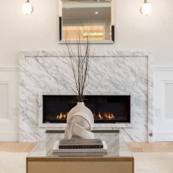 A white marble fireplace instantly elevates a space with its elegant and timeless appeal