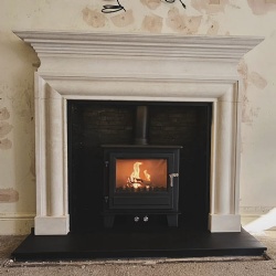 Bespoke stone fireplace surround for home interior