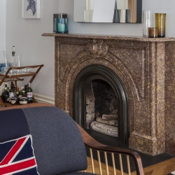 Brown marble fireplace in an eclectic space