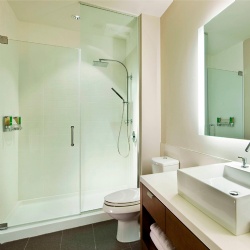 Hotel bath vanities and glass shower door