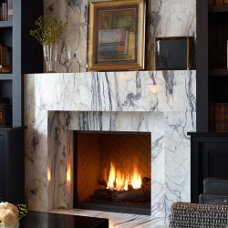 Marble-Wrapped Fireplace with Floor-to-Ceiling Library Storage