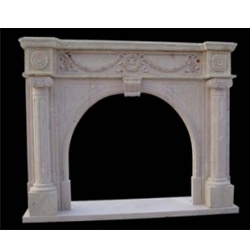 Marble fire surround with arched opening and fluted ionic columns