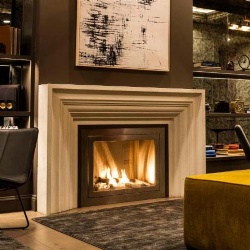Modern style limestone fireplace mantel in hotel lobby