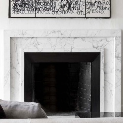 White marble fireplace mantel matching black firebox