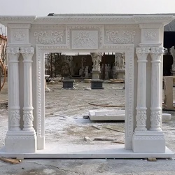 White marble fireplace mantel with fluted column and decorative capital and base